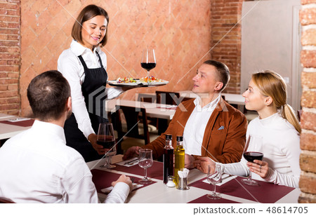 Waitress placing order in front of guests Waitress placing order in front of guests 48614705