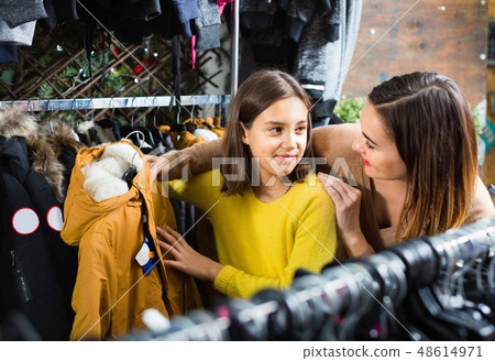 Mother and daughter choosing new coat 48614971