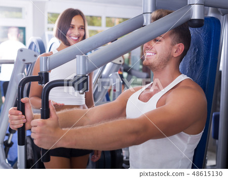 Female assisting man using fly machine Female assisting man using fly machine 48615130
