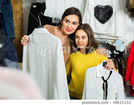Mother and daughter choosing pretty blouse Mother and daughter choosing pretty blouse 48615132