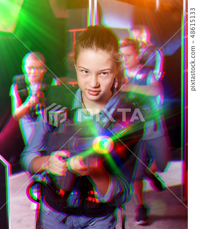 Teen girl with laser pistol on dark labyrinth Teen girl with laser pistol on dark labyrinth 48615133