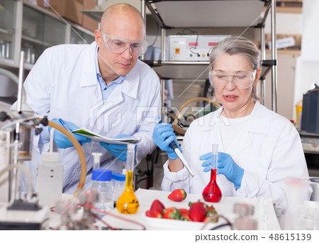 Biochemists recording experimental procedure and results Biochemists recording experimental procedure and results 48615139