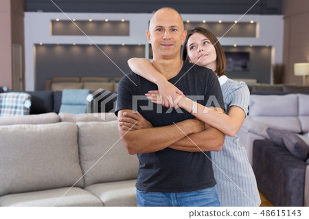 Husband and wife posing in room with sofas Husband and wife posing in room with sofas 48615143