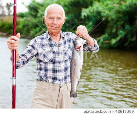 Fisherman holding fresh catch fish Fisherman holding fresh catch fish 48615399