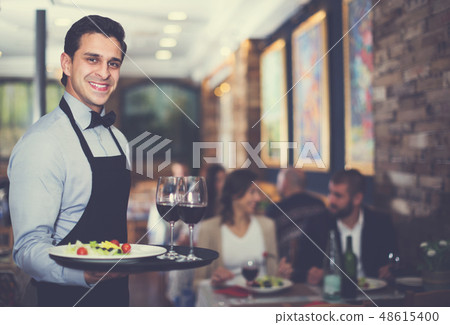 Waiter posing in restaurant Waiter posing in restaurant 48615400