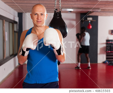 Potrait of man boxer who is training in gym Potrait of man boxer who is training in gym 48615503