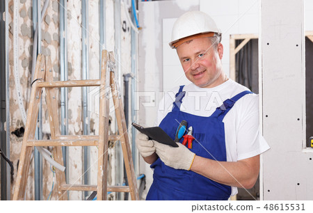 Contractor with phone in hands 48615531
