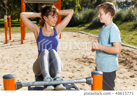 Woman with boy doing push-ups 48615771