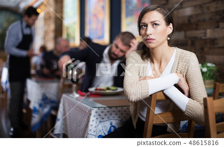 quarreled visitors female and male in restaurant 48615816