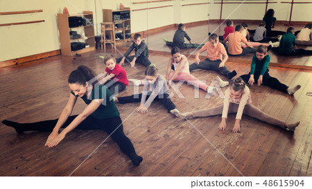 children with trainer stretching children with trainer stretching 48615904