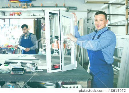 Workmen inspecting PVC manufacturing output in workshop Workmen inspecting PVC manufacturing output in workshop 48615952