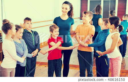 Boys and girls studying folk dance in studio Boys and girls studying folk dance in studio 48616150