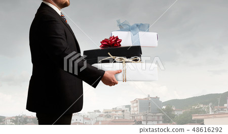 Businessman hold gift box Businessman hold gift box 48616292
