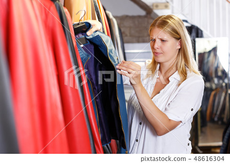 woman expressing displeasure with quality and price of jacket 48616304