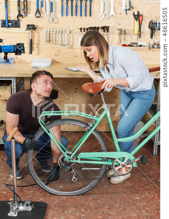 Male and female are pumping bicycle wheels Male and female are pumping bicycle wheels 48616505