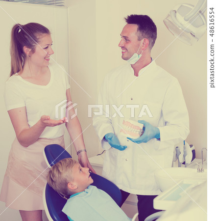 Woman is talking with stomatologist about her child`s health Woman is talking with stomatologist about her child`s health 48616554