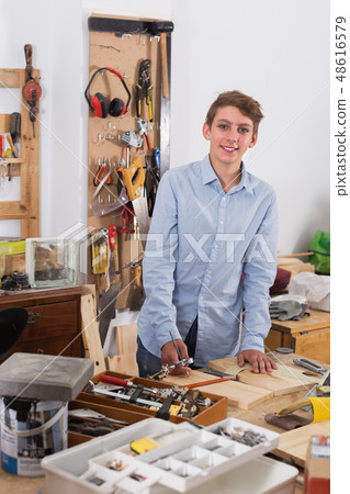 Teenager working with wood Teenager working with wood 48616579