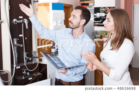 Family couple looking for new modern functional shower mixer 48616698