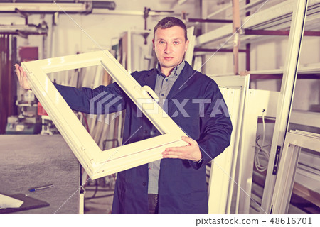 Handsome labour demonstrating PVC profiles Handsome labour demonstrating PVC profiles 48616701