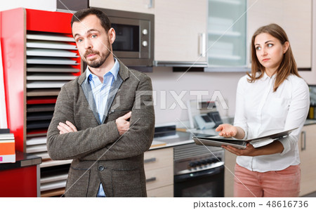 Man upset because of lack of necessary materials for kitchen furniture in store 48616736