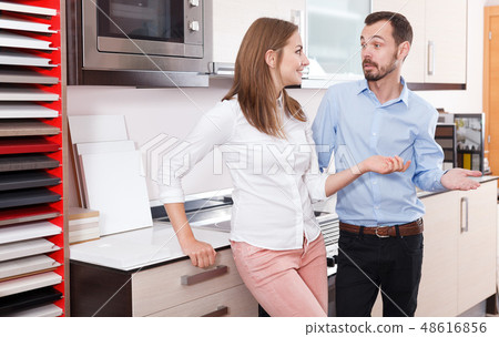 Couple talking in kitchen furnishing store Couple talking in kitchen furnishing store 48616856
