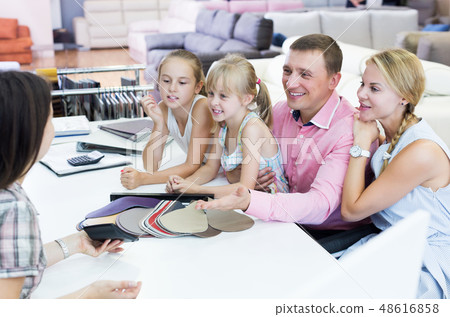 Family is consulting with the shop assistant Family is consulting with the shop assistant 48616858