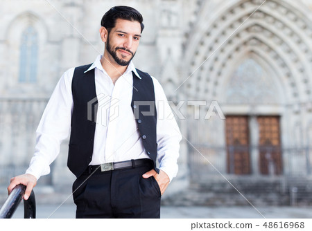 Waist up portrait of man near iron railings Waist up portrait of man near iron railings 48616968