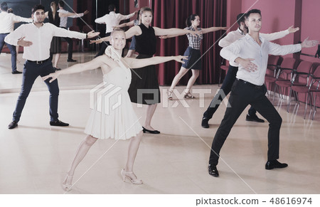 Dancing couples enjoying latin dances Dancing couples enjoying latin dances 48616974