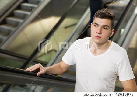 Passenger riding moving staircase in underground 48616975