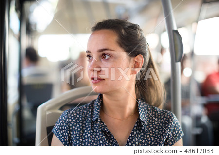 passenger taking bus journey 48617033