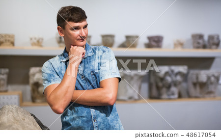 Man looking architectural elements in museum Man looking architectural elements in museum 48617054