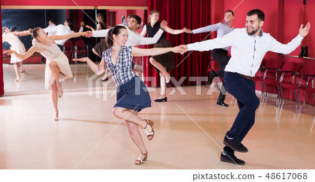 Dancing couples enjoying latin dances Dancing couples enjoying latin dances 48617068