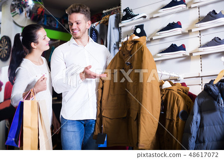 Couple choosing new coat Couple choosing new coat 48617072