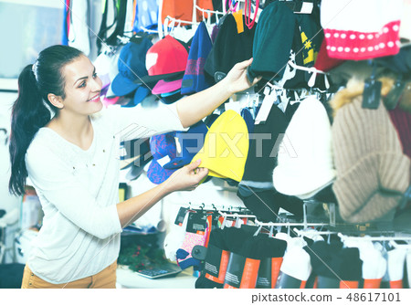 Woman choosing new knit cap Woman choosing new knit cap 48617101