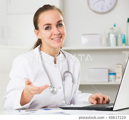 Female doctor waiting for patients Female doctor waiting for patients 48617220