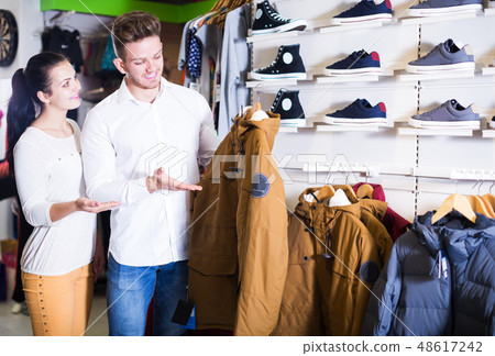 Couple choosing new coat Couple choosing new coat 48617242