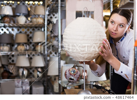Woman buying new lamp 48617464