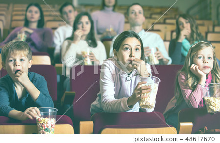 Number of people enjoying film screening and popcorn Number of people enjoying film screening and popcorn 48617670