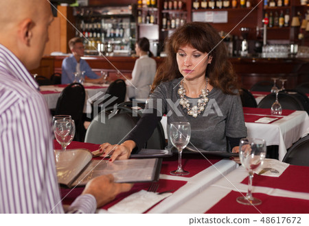 Woman discussing menu with husband Woman discussing menu with husband 48617672