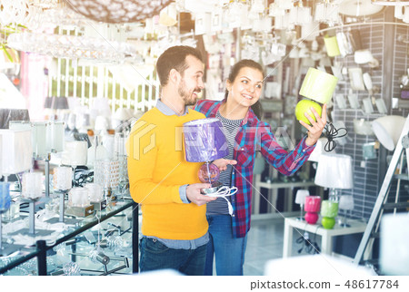 Smiling young man and girl in lighter shop choose night light 48617784