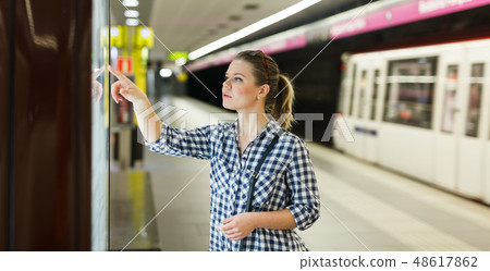 Woman looking at map at metro station Woman looking at map at metro station 48617862
