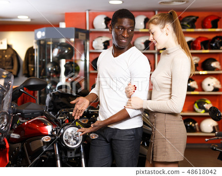 couple in motorcycle shop choosing new vehicle couple in motorcycle shop choosing new vehicle 48618042