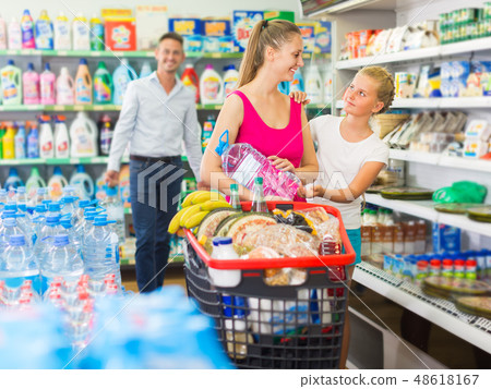 Family is selecting goods 48618167