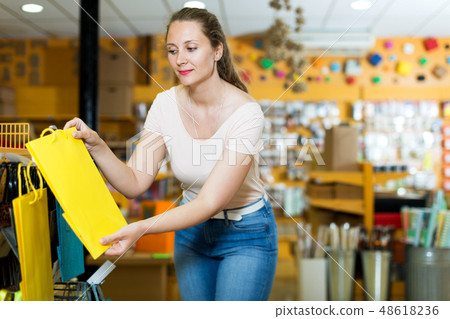 Woman demonstrates multi colored bags 48618236