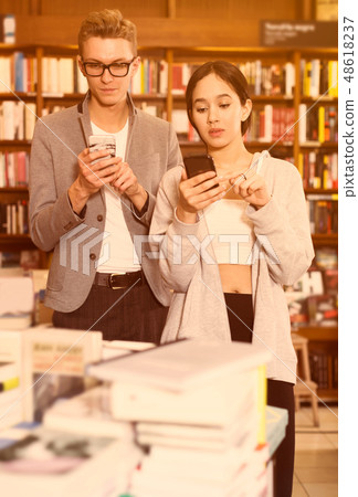 students using phones in library students using phones in library 48618237
