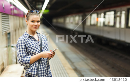 Woman waiting for train at subway station 48618410