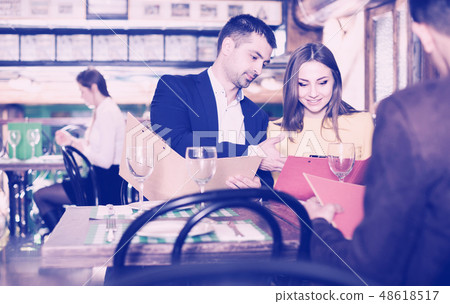 Couple is choosing order for dinner Couple is choosing order for dinner 48618517