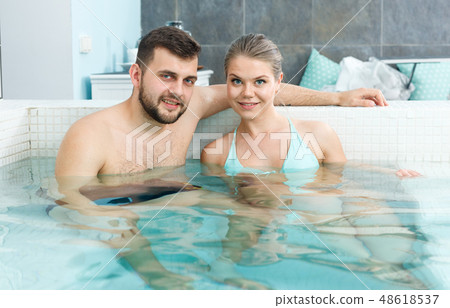 Couple relaxing in hot tub Couple relaxing in hot tub 48618537