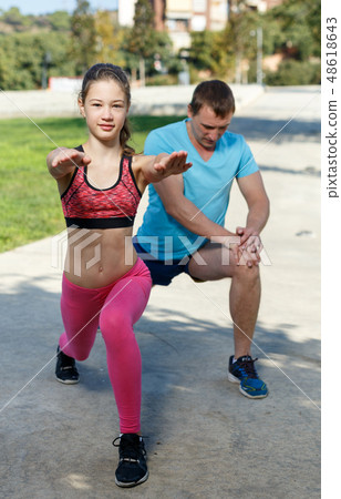 Girl stretching together with father Girl stretching together with father 48618643