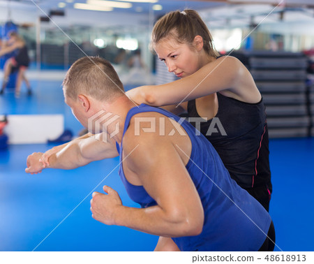 Active female is fighting with trainer 48618913